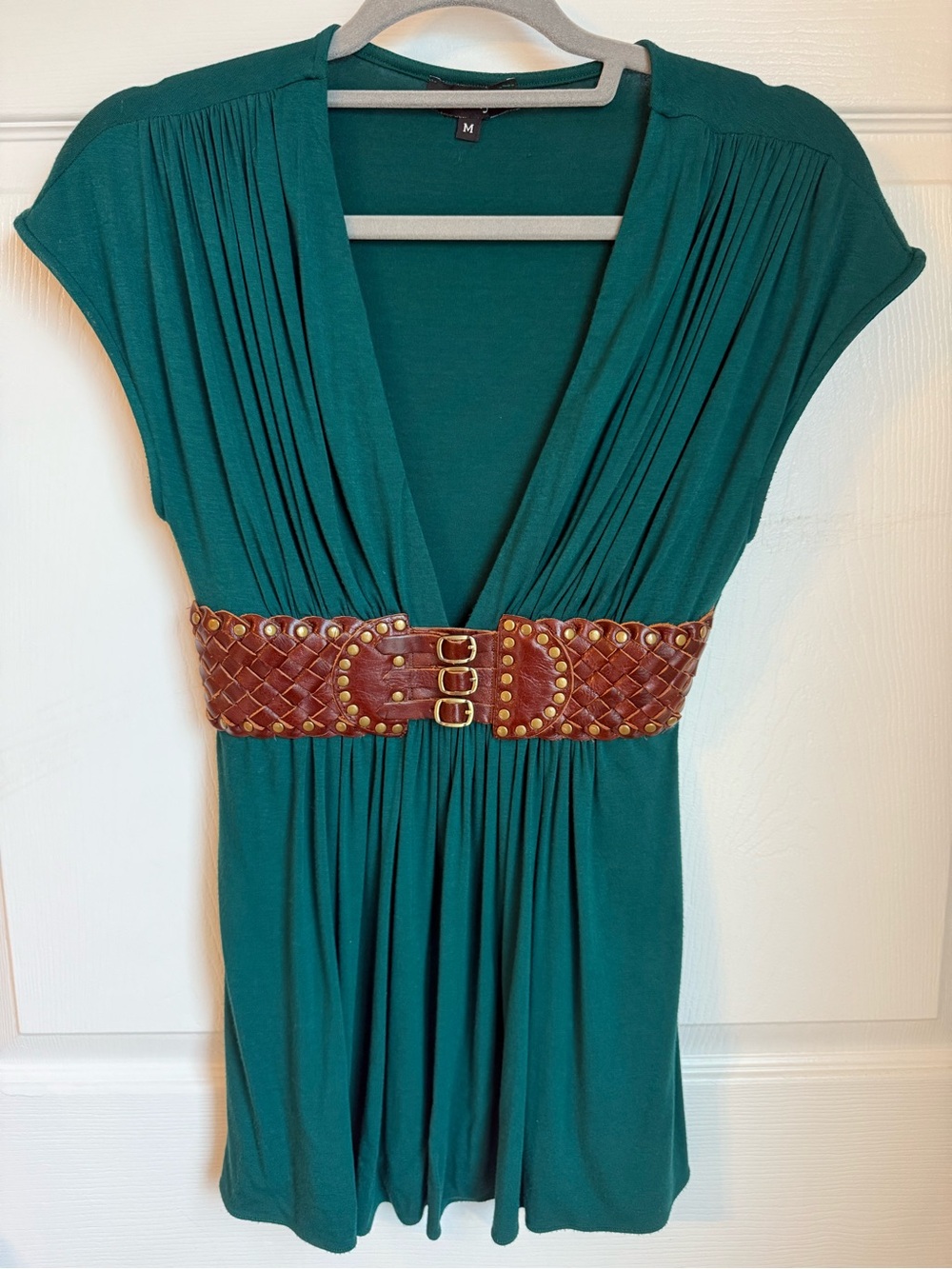 Women’s dark green v-neck top with brown belt detail